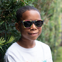 Thumbnail for Little boy wearing coral snake print sunglasses by Sunnies with polarized lenses and 100% UVA/UVB protection