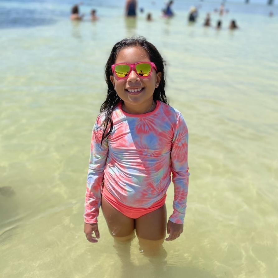 Little girl wearing pink polarized kids sunglasses by sunnies shades