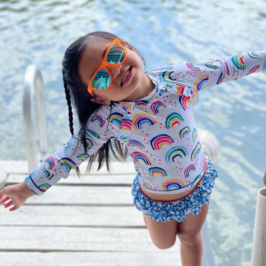 Little girl wearing orange polarized kids sunglasses by sunnies shades.