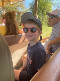 Boy wearing tiger print Sunnies on a Disney safari at Animal Kingdom
