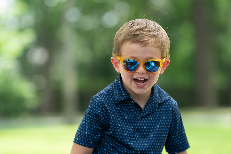 Cute boy wearing Just Monkeying Around polarized sunnies shades with transparent yellow frame and reflective blue polarized lenses